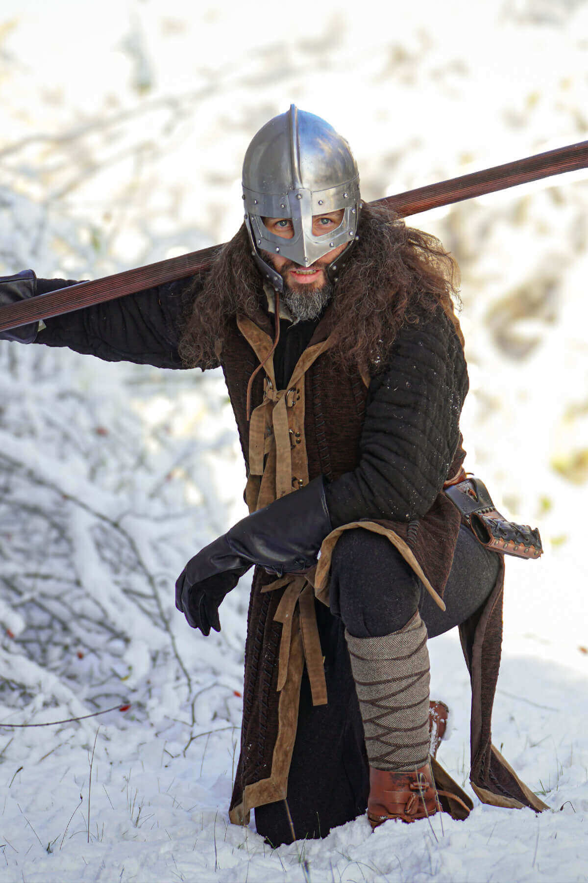 Person in Viking attire with a spear in a snowy landscape